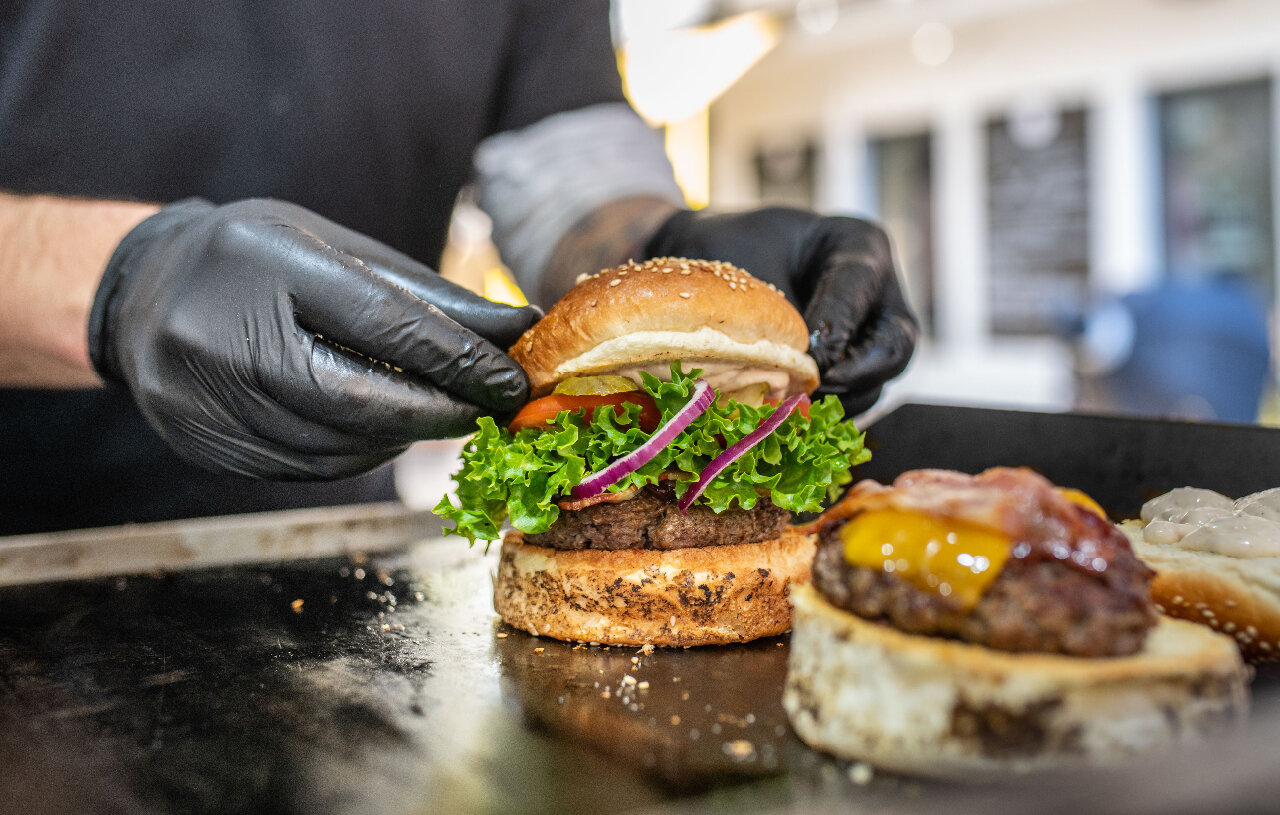Person preparing a burger